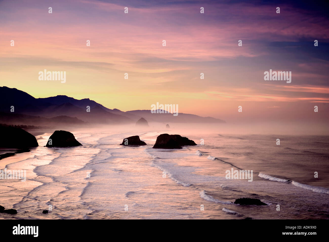 Sunrise and clouds with waves Cannon Beach Oregon Stock Photo