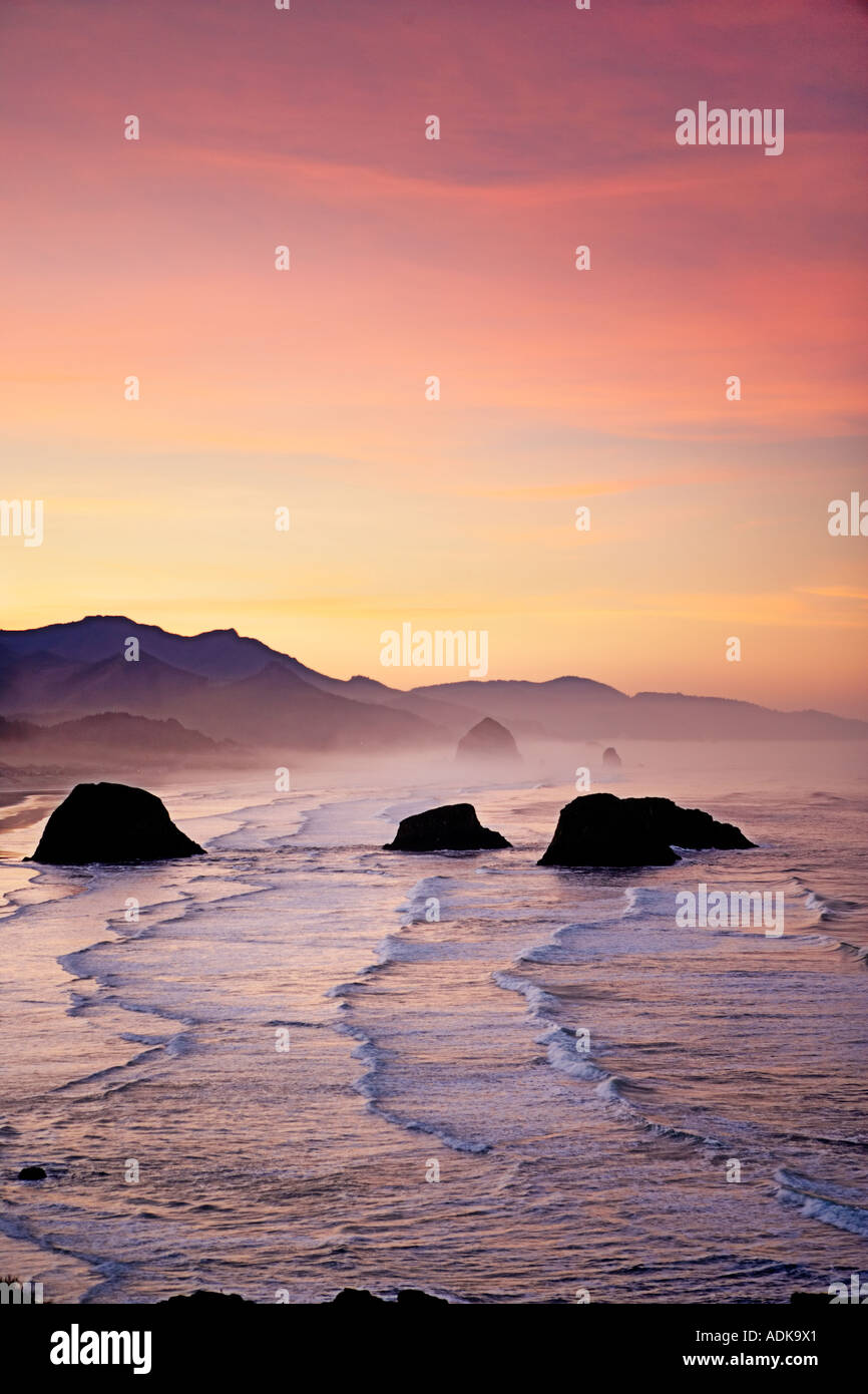 Sunrise and clouds with waves Cannon Beach Oregon Stock Photo