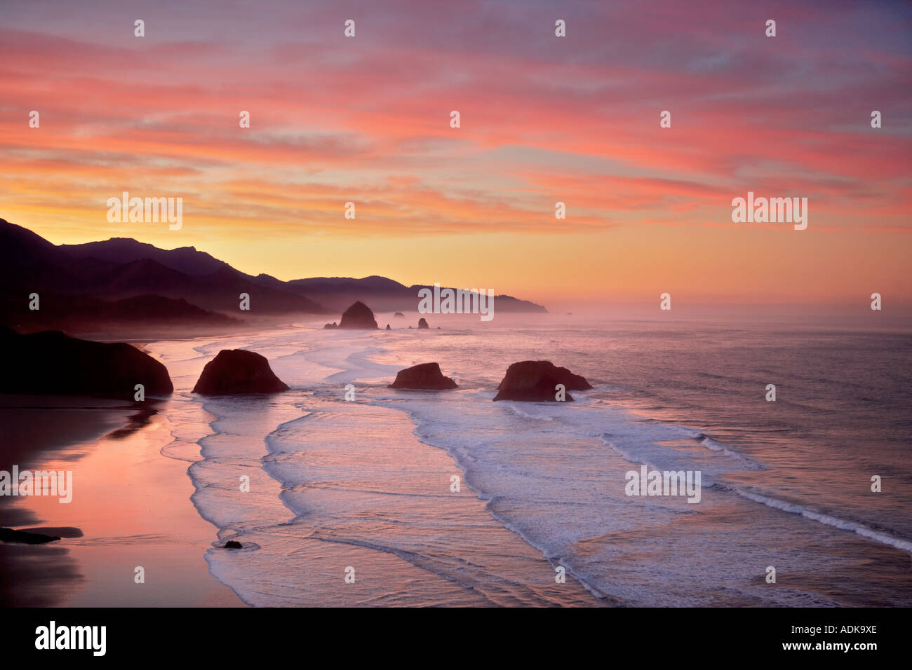 Sunrise and clouds with waves Cannon Beach Oregon Stock Photo