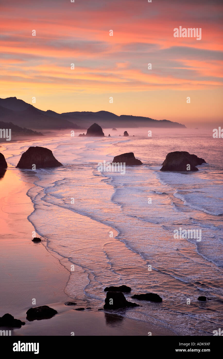 Sunrise and clouds with waves Cannon Beach Oregon Stock Photo