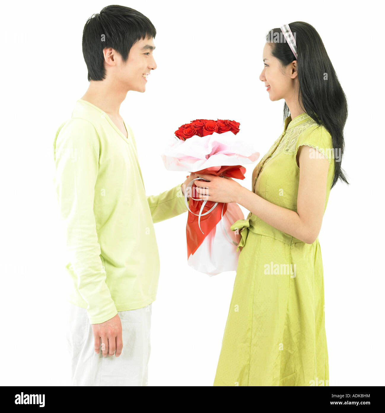 a boy giving a rose bouquet to his girl friend Stock Photo