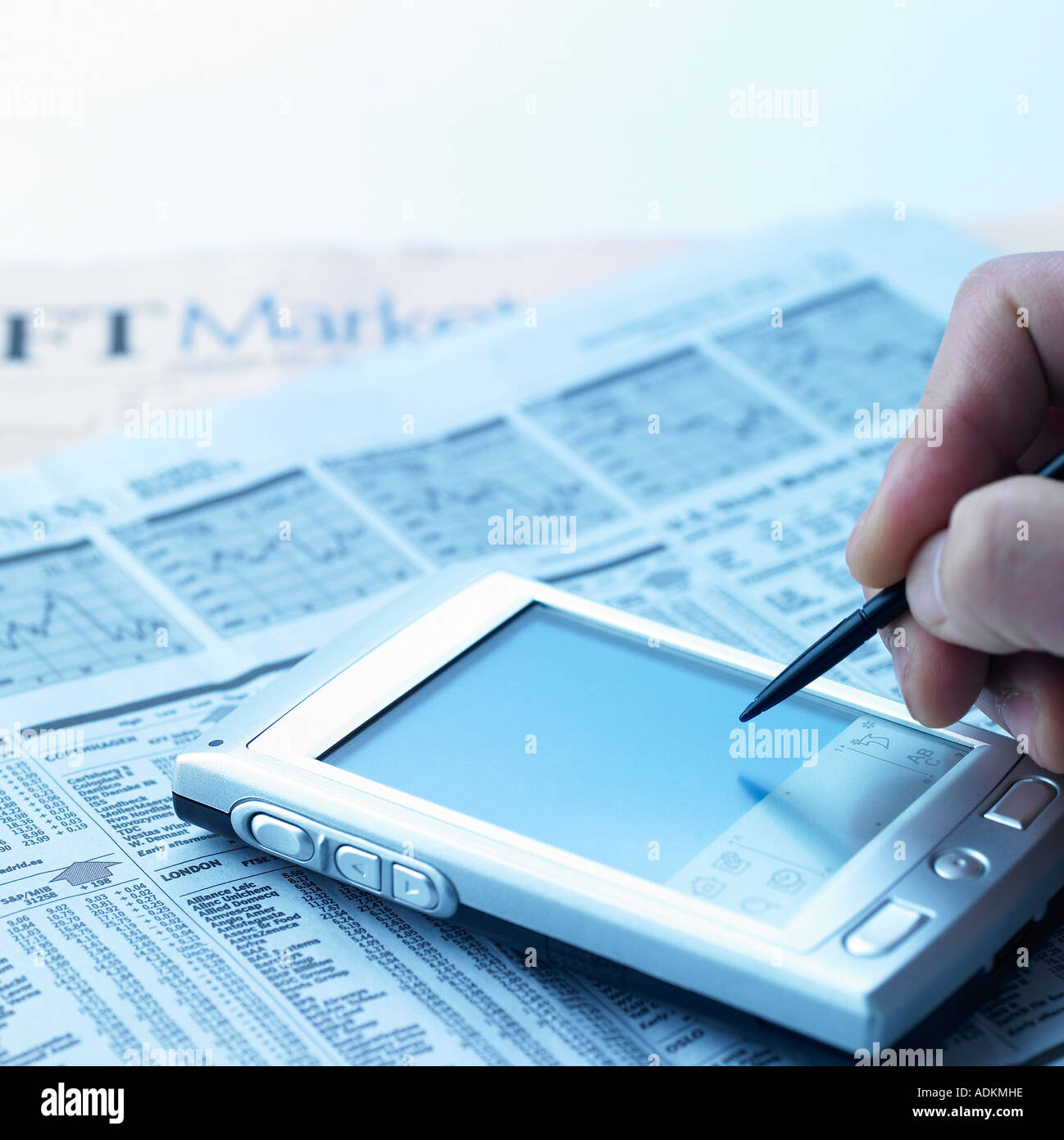 business concept a PDA and an electric pen on a newspaper Stock Photo