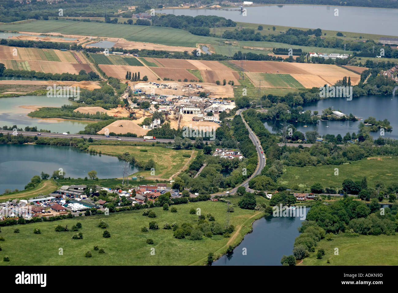 Oblique high level aerial view north of Addlestone with a gravel pit ...