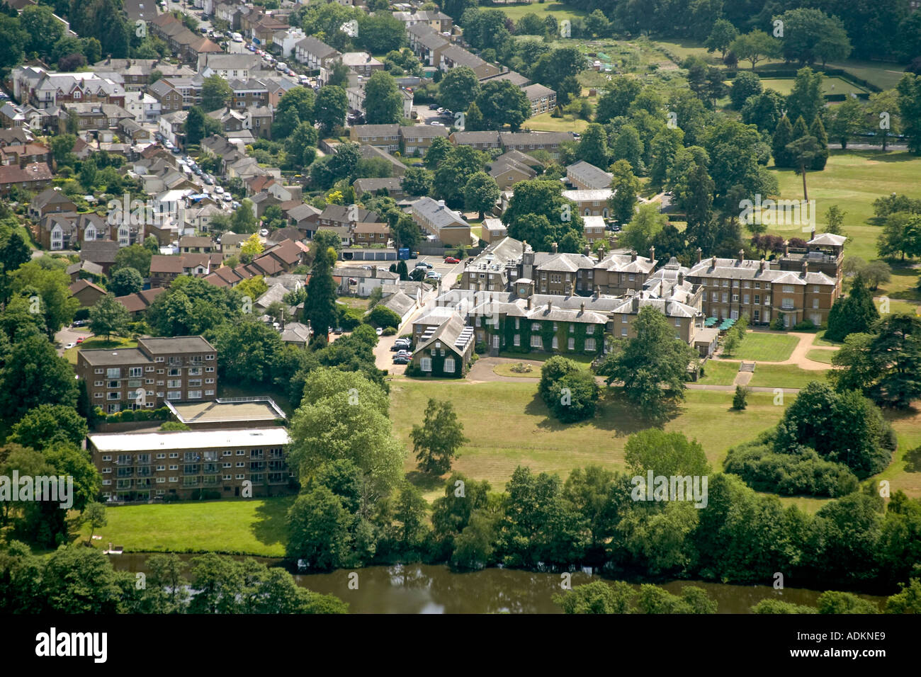 Oblique high level aerial view south of Weybridge with Oatlands Park