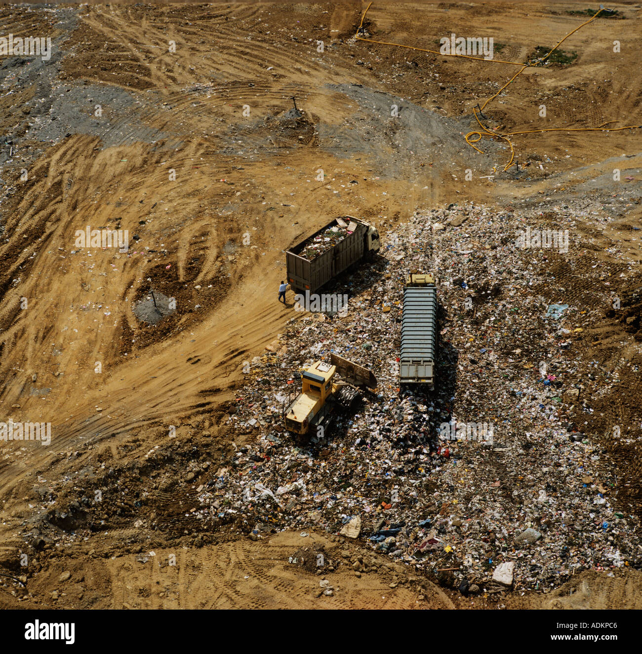 Lorries dumping rubbish at landfill site UK aerial view Stock Photo