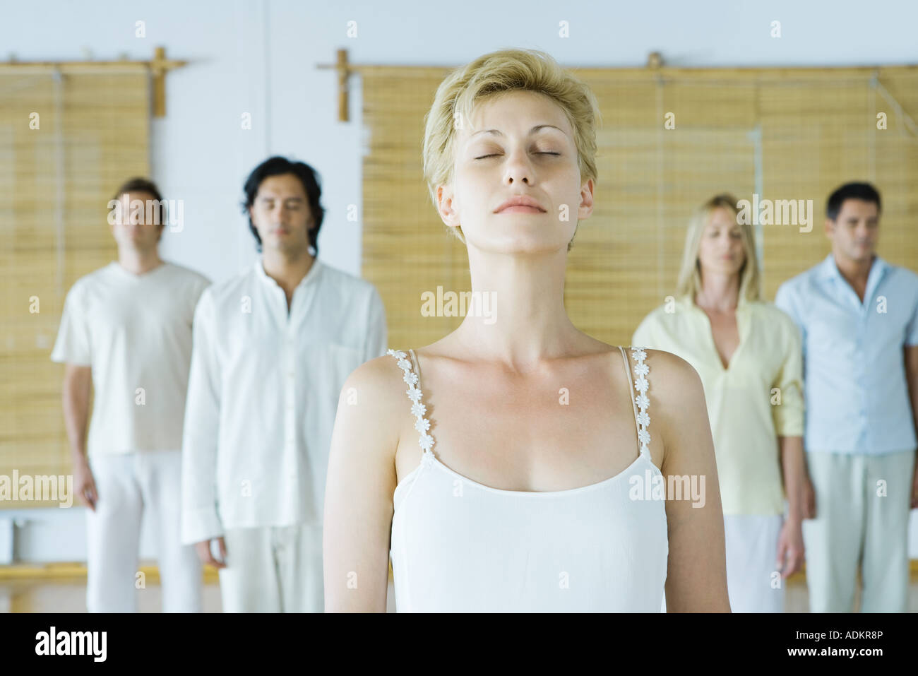 Group meditation, adults standing with eyes closed Stock Photo Alamy