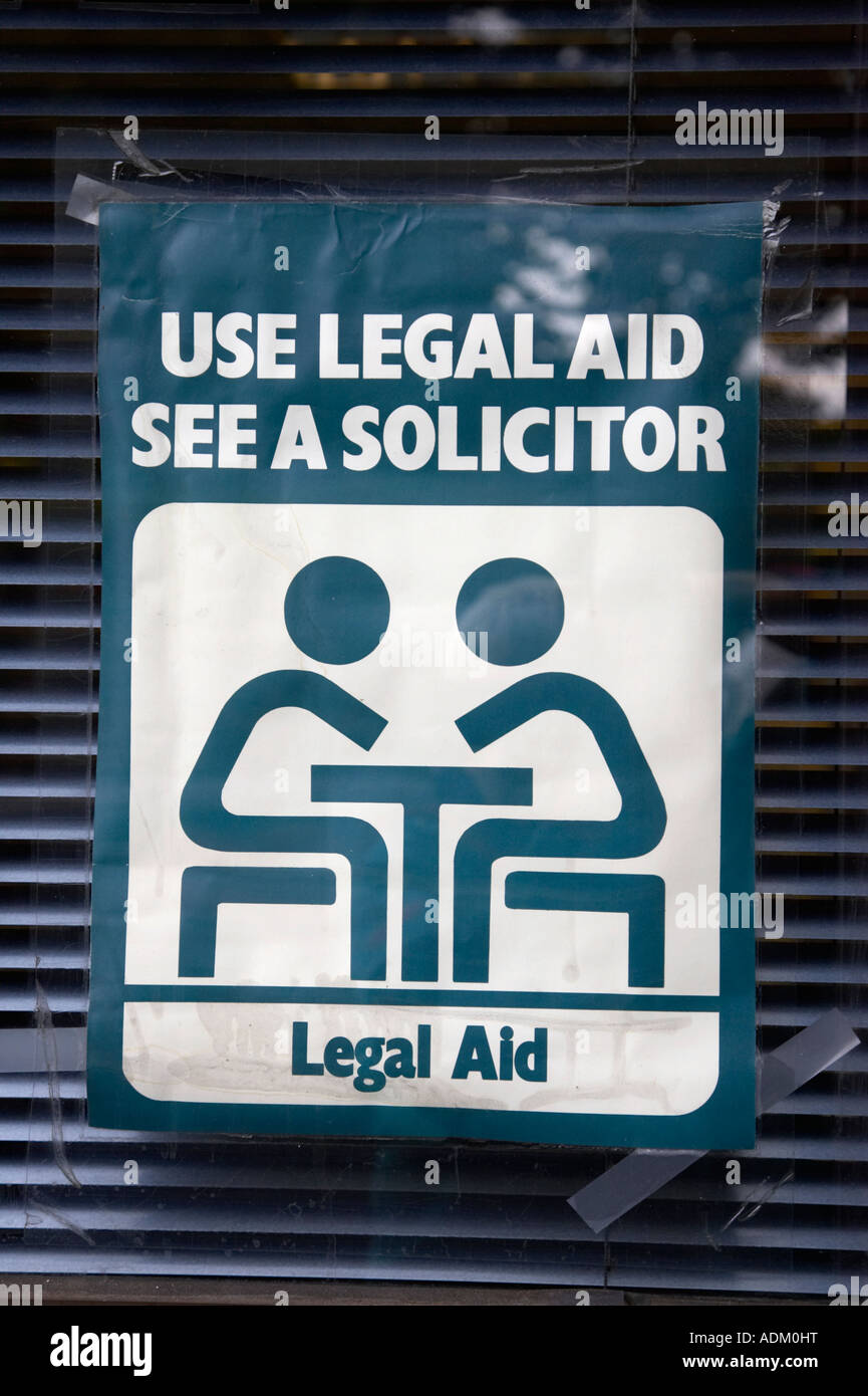 use legal aid see a solicitor sign taped to the inside window of a solicitors office with venetian blind Stock Photo