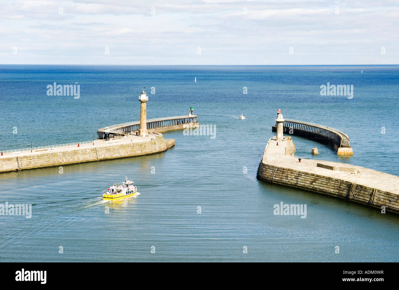 Pleasure boat sailing out of whitby harbour Stock Photo