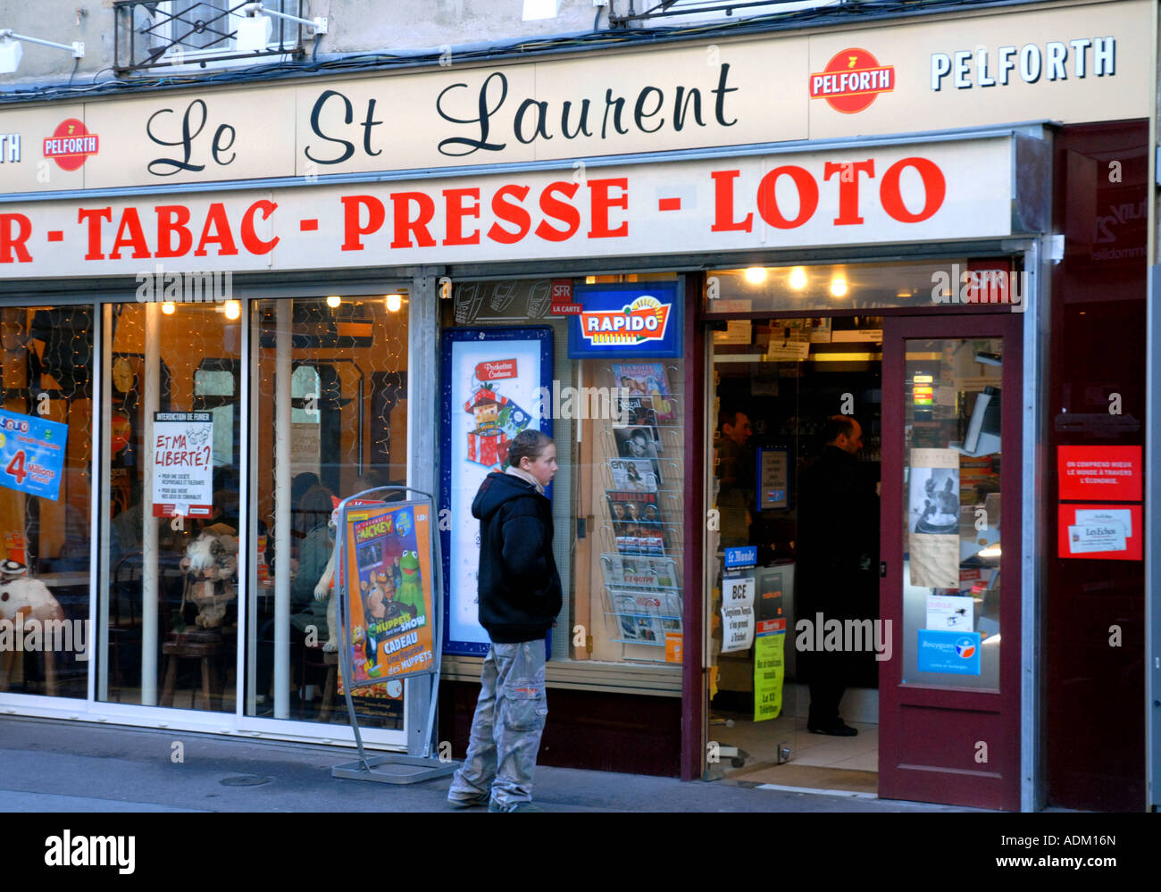 Teenage Boy Outside Tabac in Side Street in Caen. Normandy, NW France. December 2006 Stock Photo