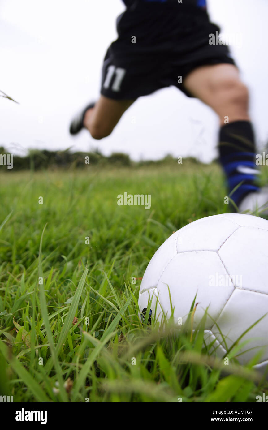 Soccer Player Running To Kick A Soccer Ball Stock Photo Alamy