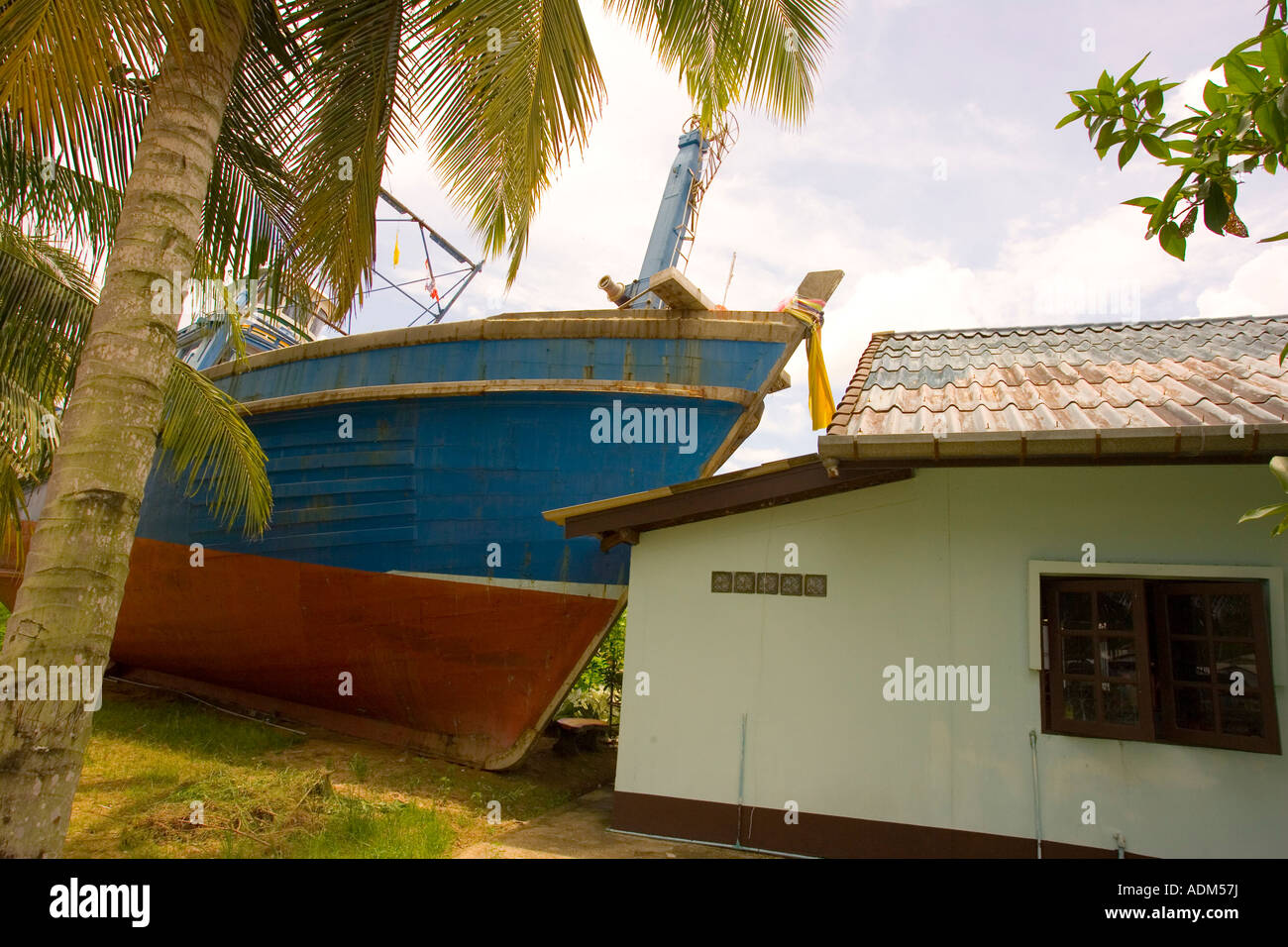 A fishing boat that was washed up against a house during the Tsunami in