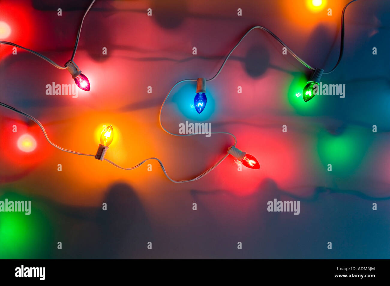 One strand of multi colored large Christmas tree lights glowing on