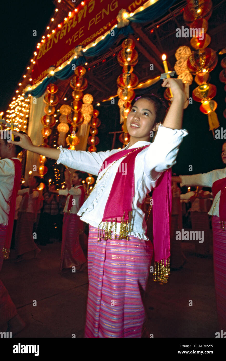 A northern Thai young woman dances the candle dance (fawn thian)during the New Year's festival of Yee Peng, Chiang Mai, Thailand Stock Photo