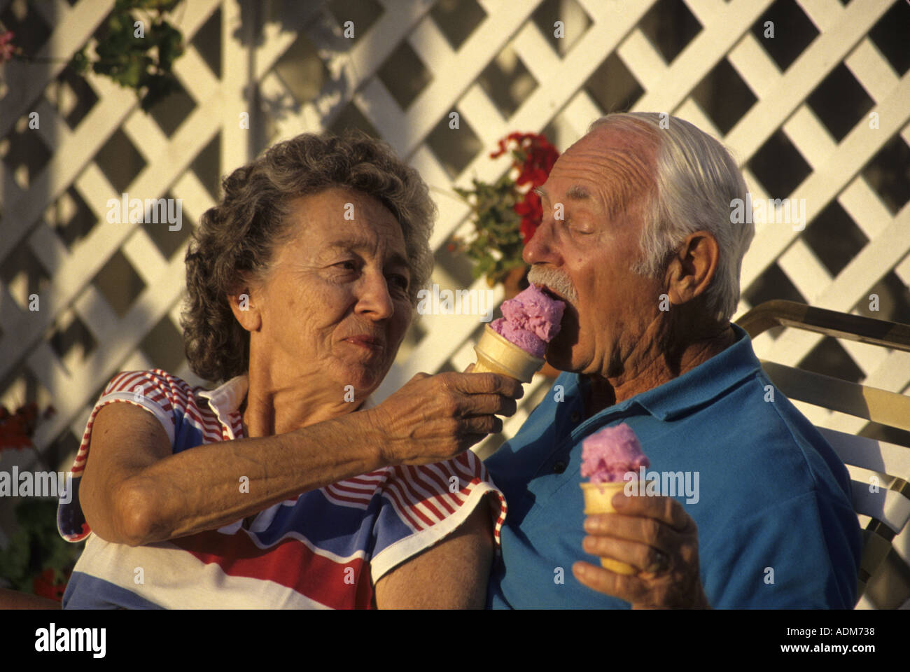 Fun loving attractive senior citizen citizens 70s couple sharing ice cream cones person people young at heart MR  © Myrleen Pearson Stock Photo
