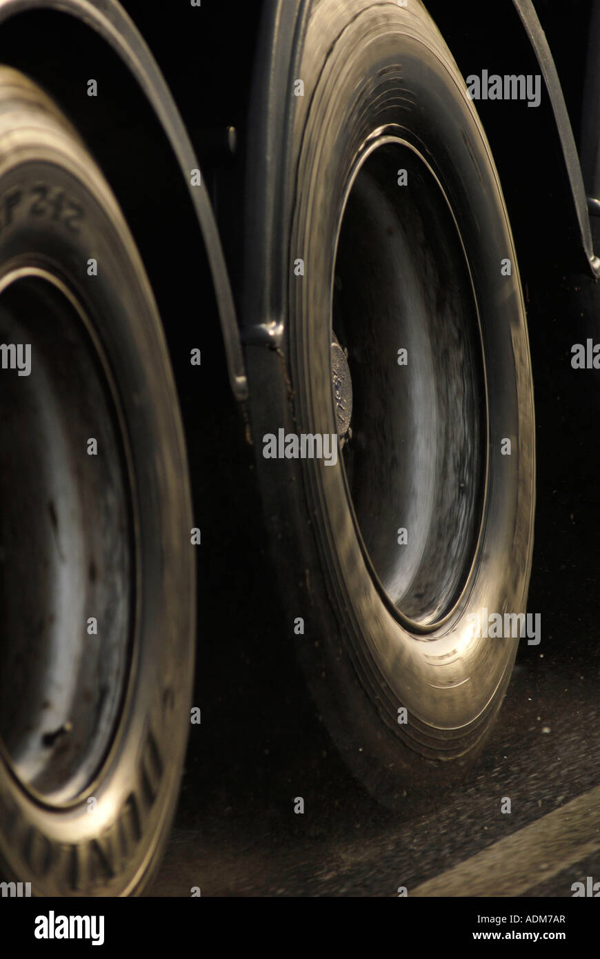 HGV lorry wheels at speed on a damp road Stock Photo