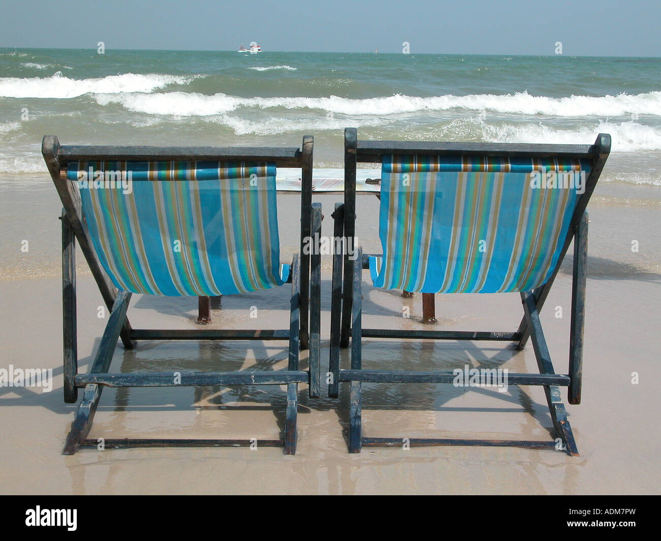 two deckchairs on a beach in thailand Stock Photo - Alamy