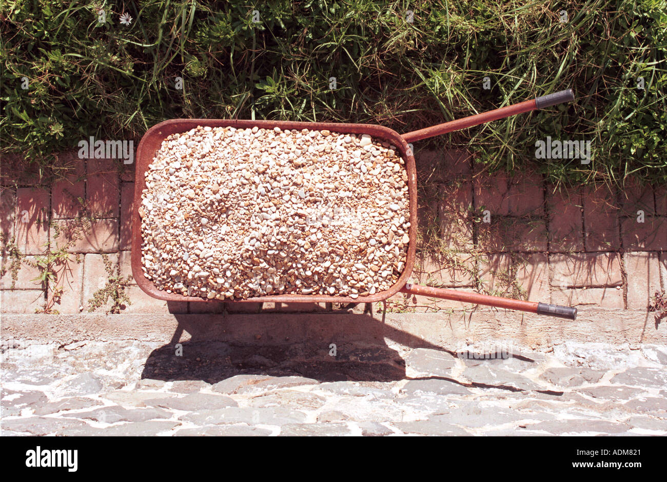 wheelbarrow full of stones gravel Stock Photo Alamy