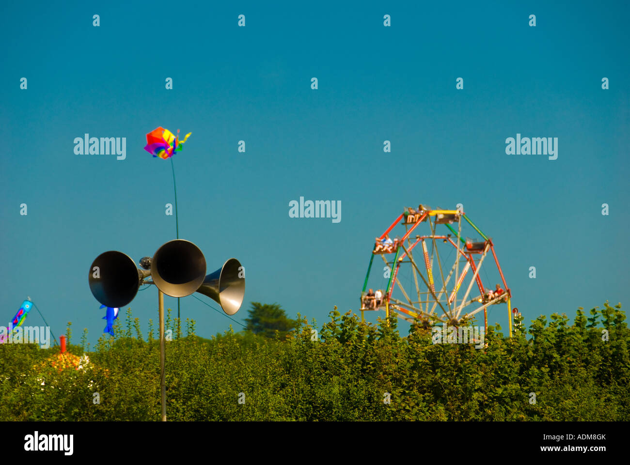 Public Address speakers at a Country Fair with a Ferris Wheel in the Background Stock Photo