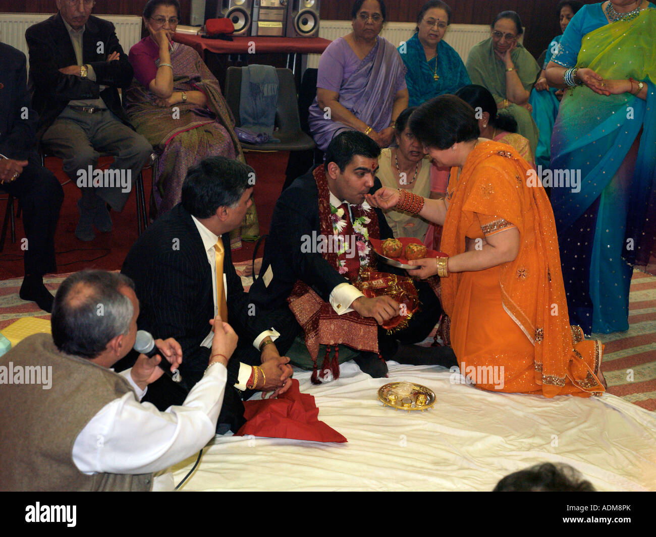Mother Feeding Son During the Hindu Engagement Ceremony at the Hindu Society Wimbledon London England Stock Photo