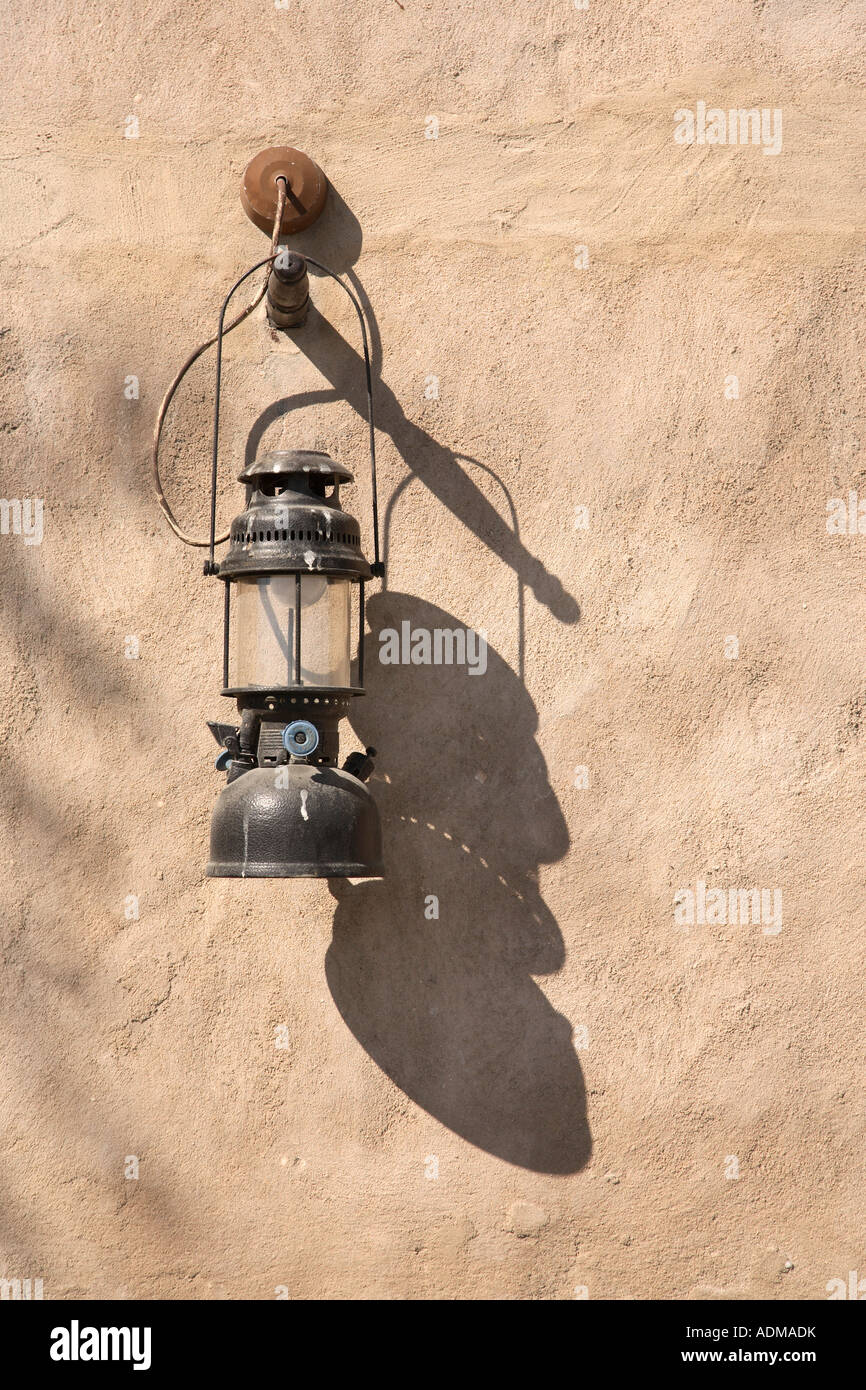 Old hurricane lamp or lantern hanging on the wall of a traditional