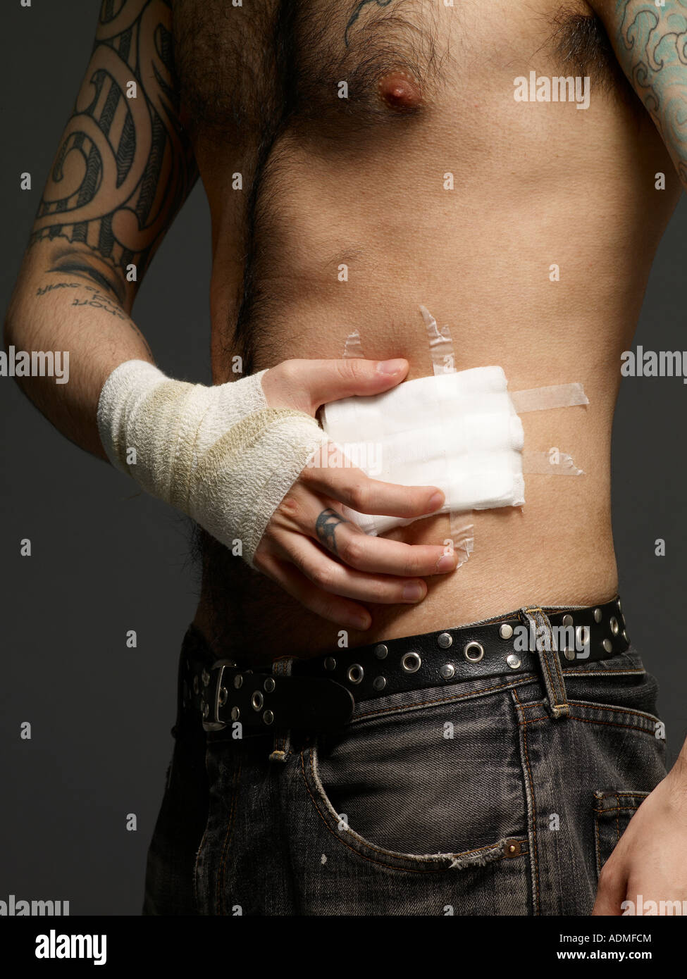 Man with bandages on his hand and torso Stock Photo - Alamy