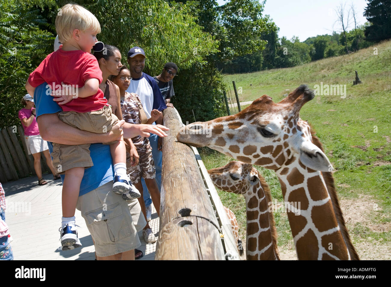 Battle Creek Michigan Visitors study the giraffes in the Wild Africa