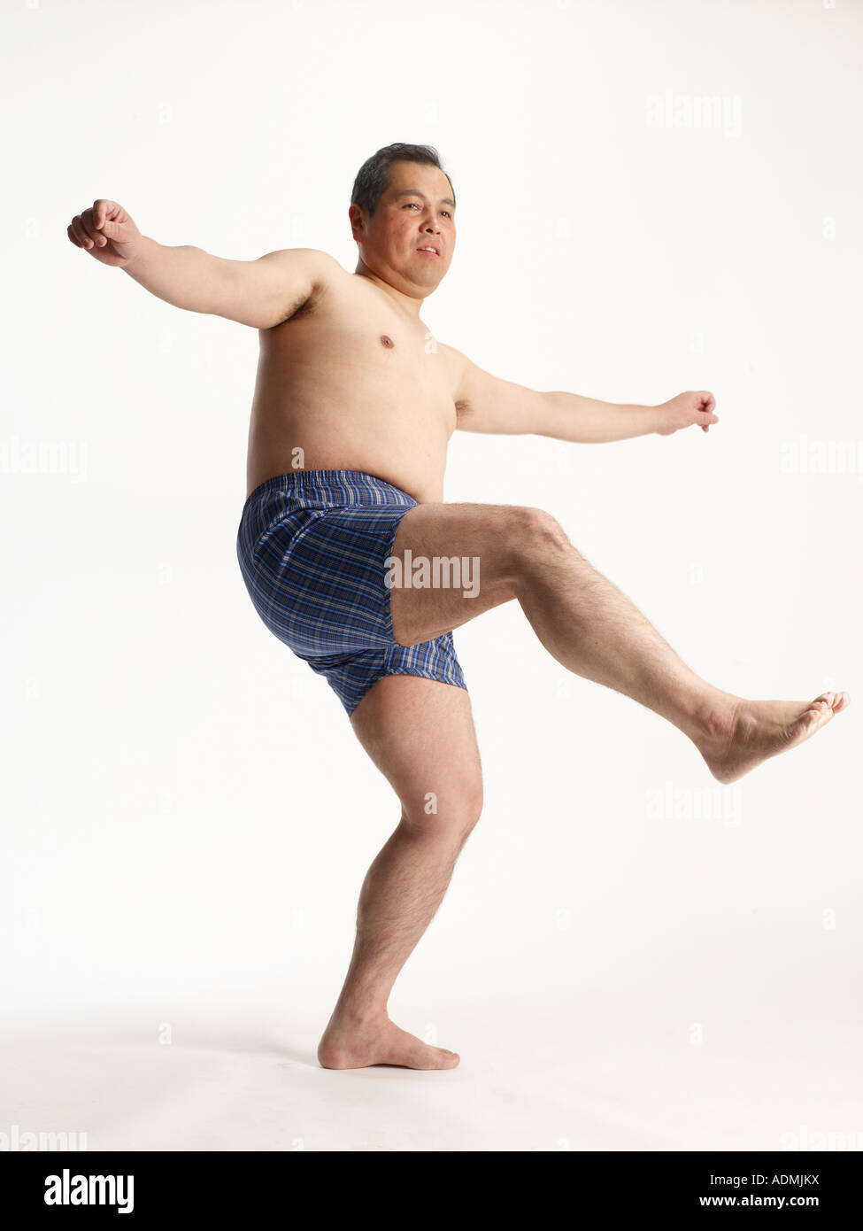 Mature man in boxer shorts balancing on one leg Stock Photo - Alamy