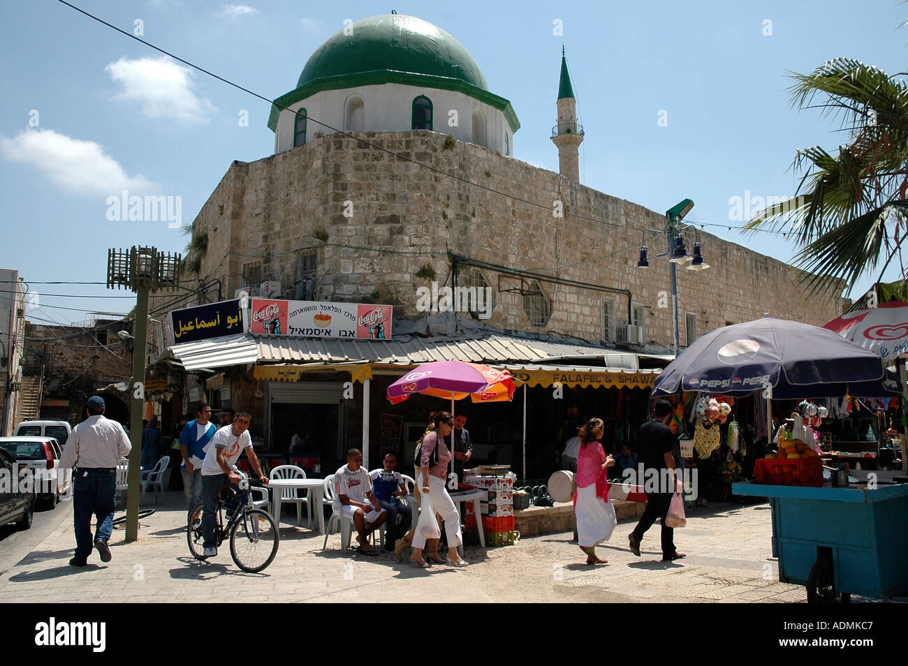 A lively corner of walled Akko or Acre almost concealing a domed mosque ...