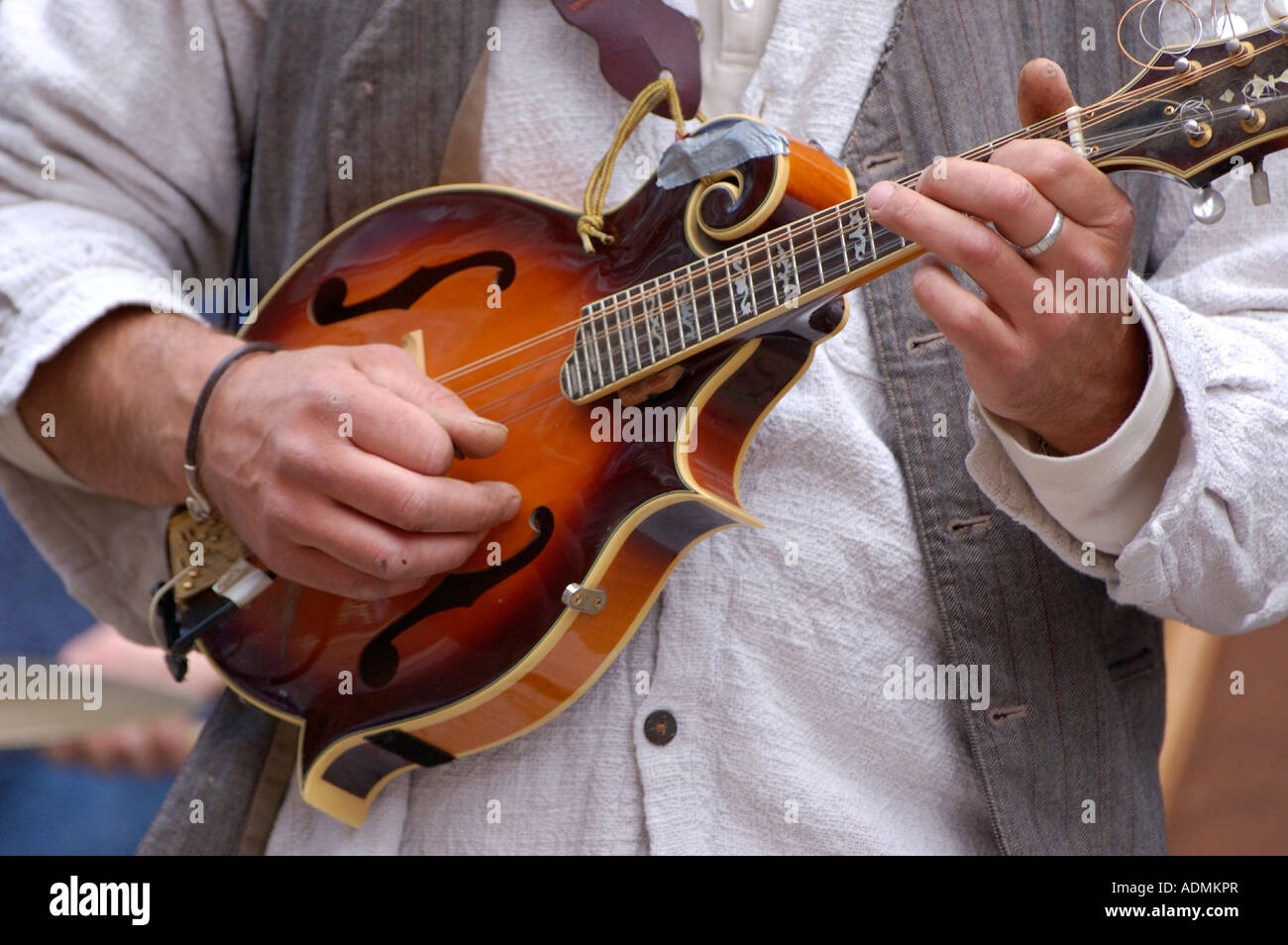 Detail of a FStyle scroll Mandolin whilst being played by a street