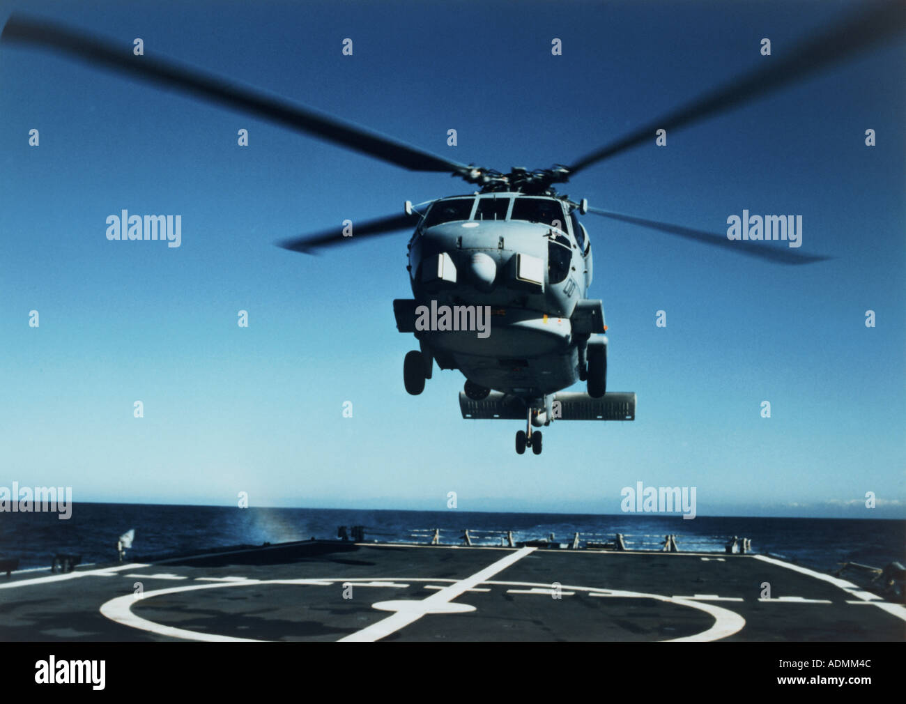 Low angle view of a SH-60B Sea Hawk helicopter landing on the deck of an aircraft carrier Stock Photo