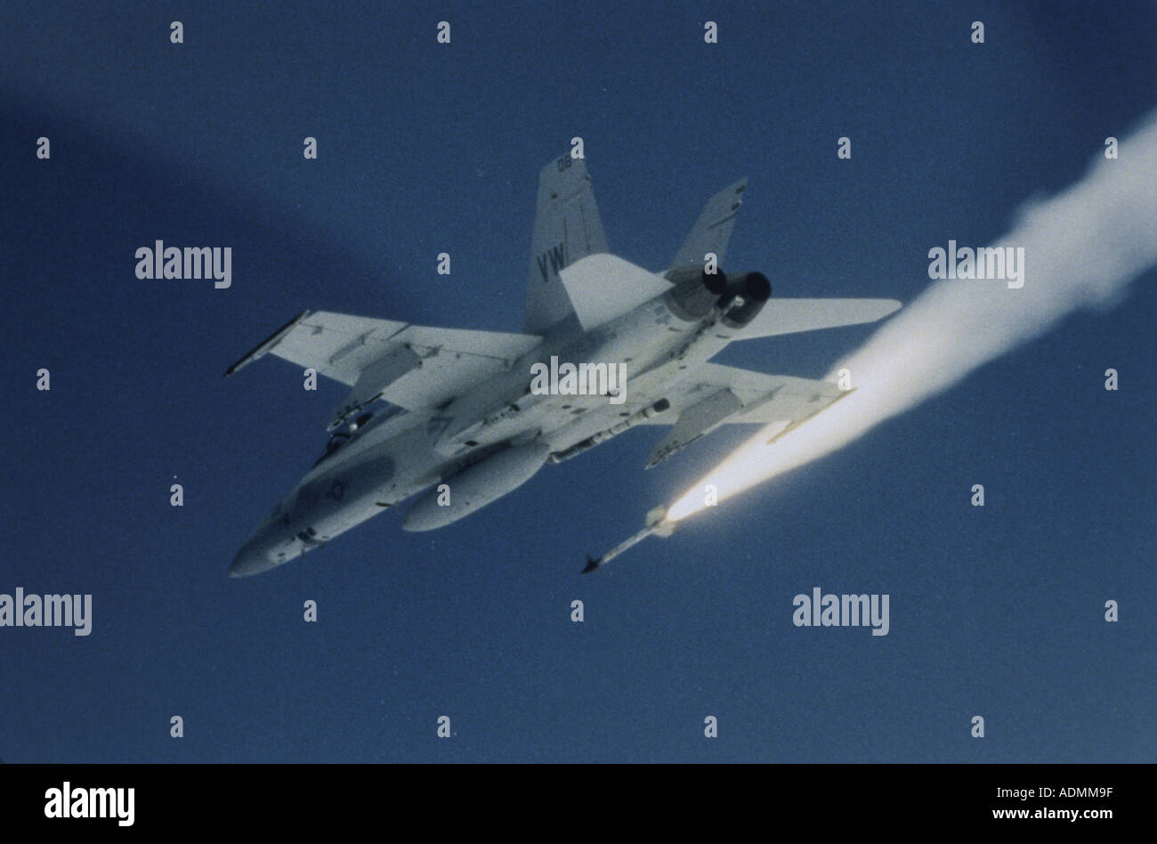 Low angle view of a fighter plane firing a missile Stock Photo