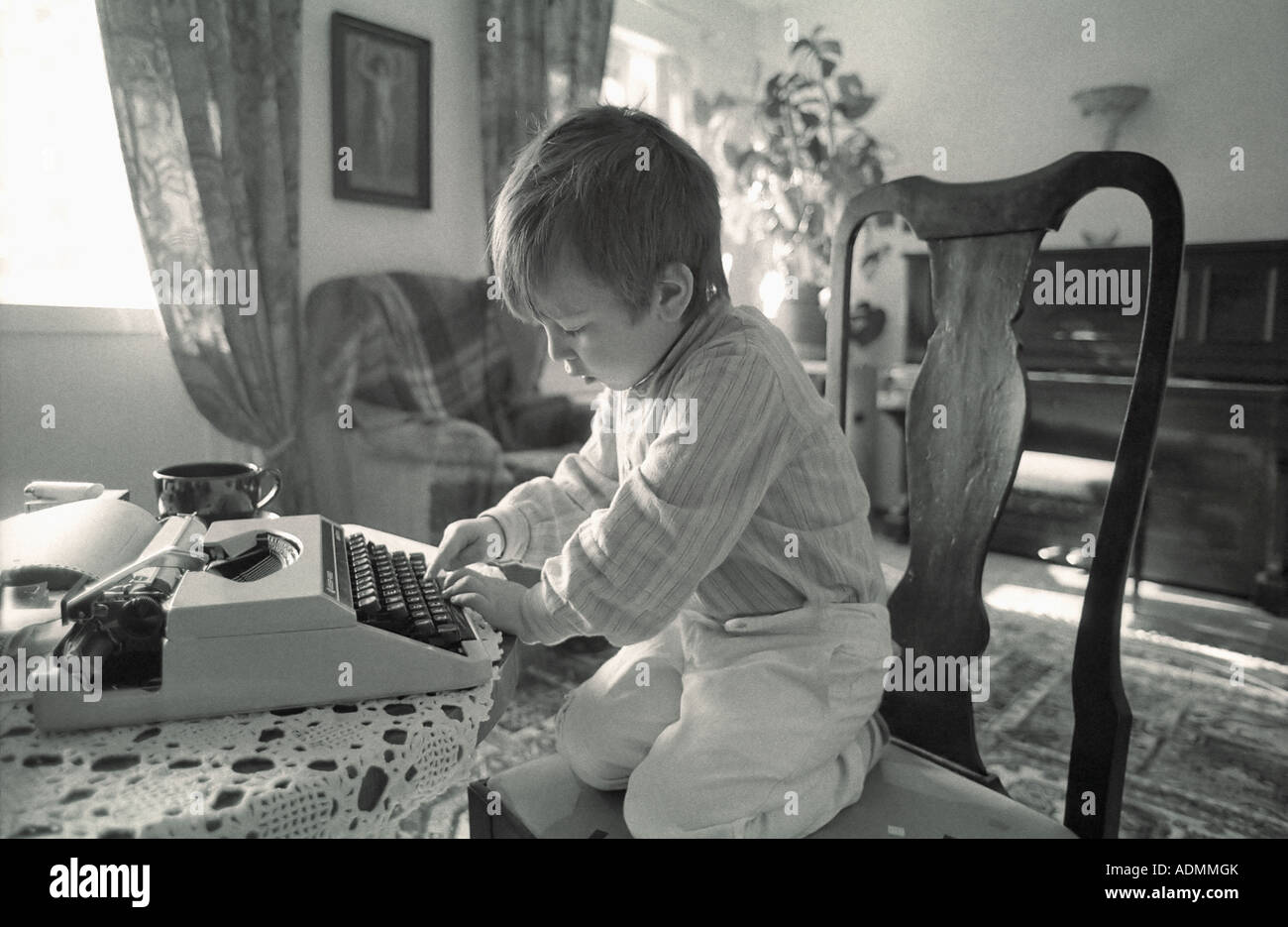 BOY WRITING ON A TYPEWRITER Stock Photo