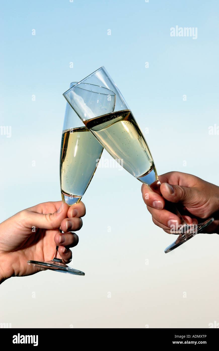 Champagne glasses held up in celebration Stock Photo