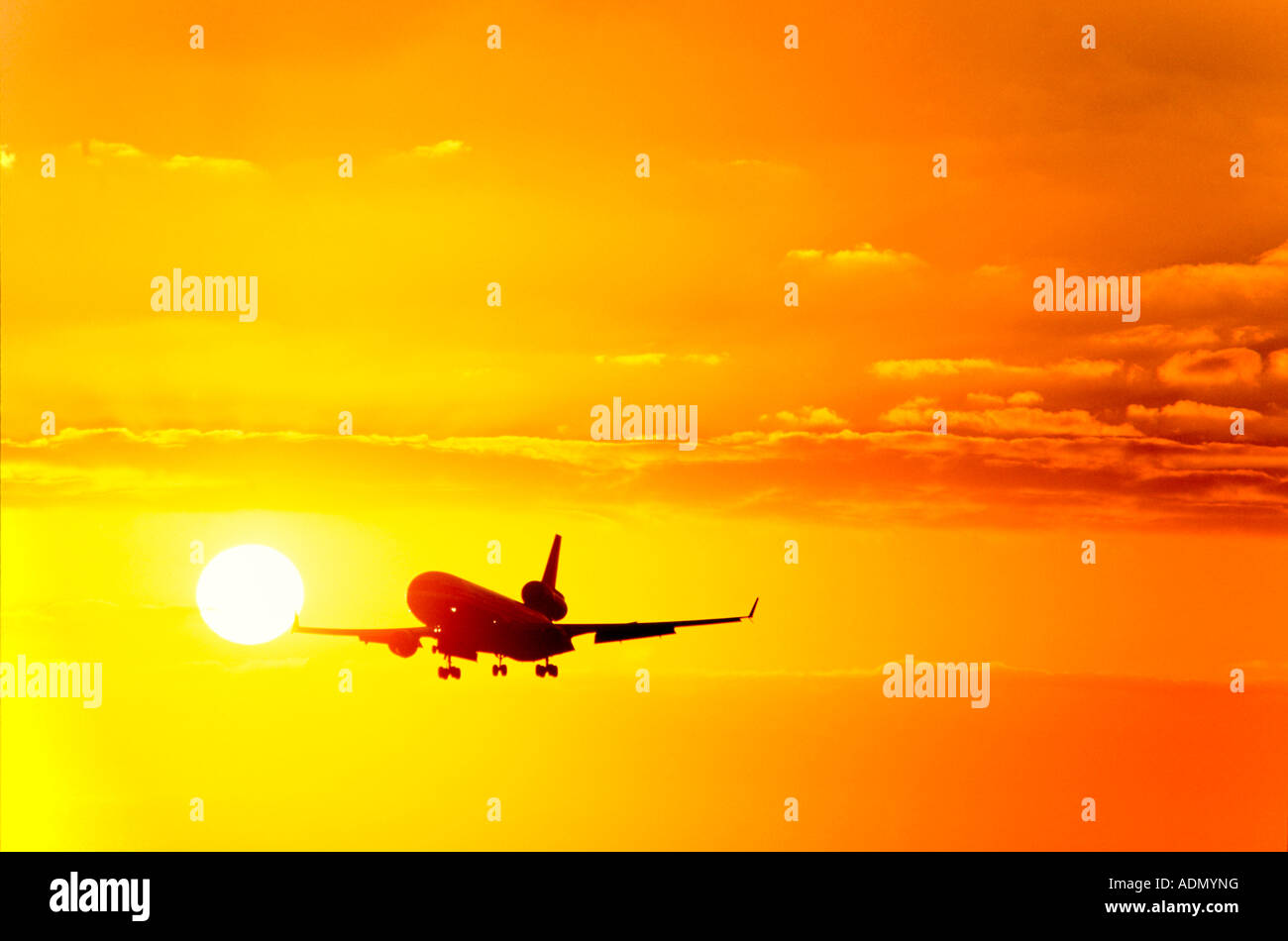 Commercial Airliner landing at Sunset Stock Photo