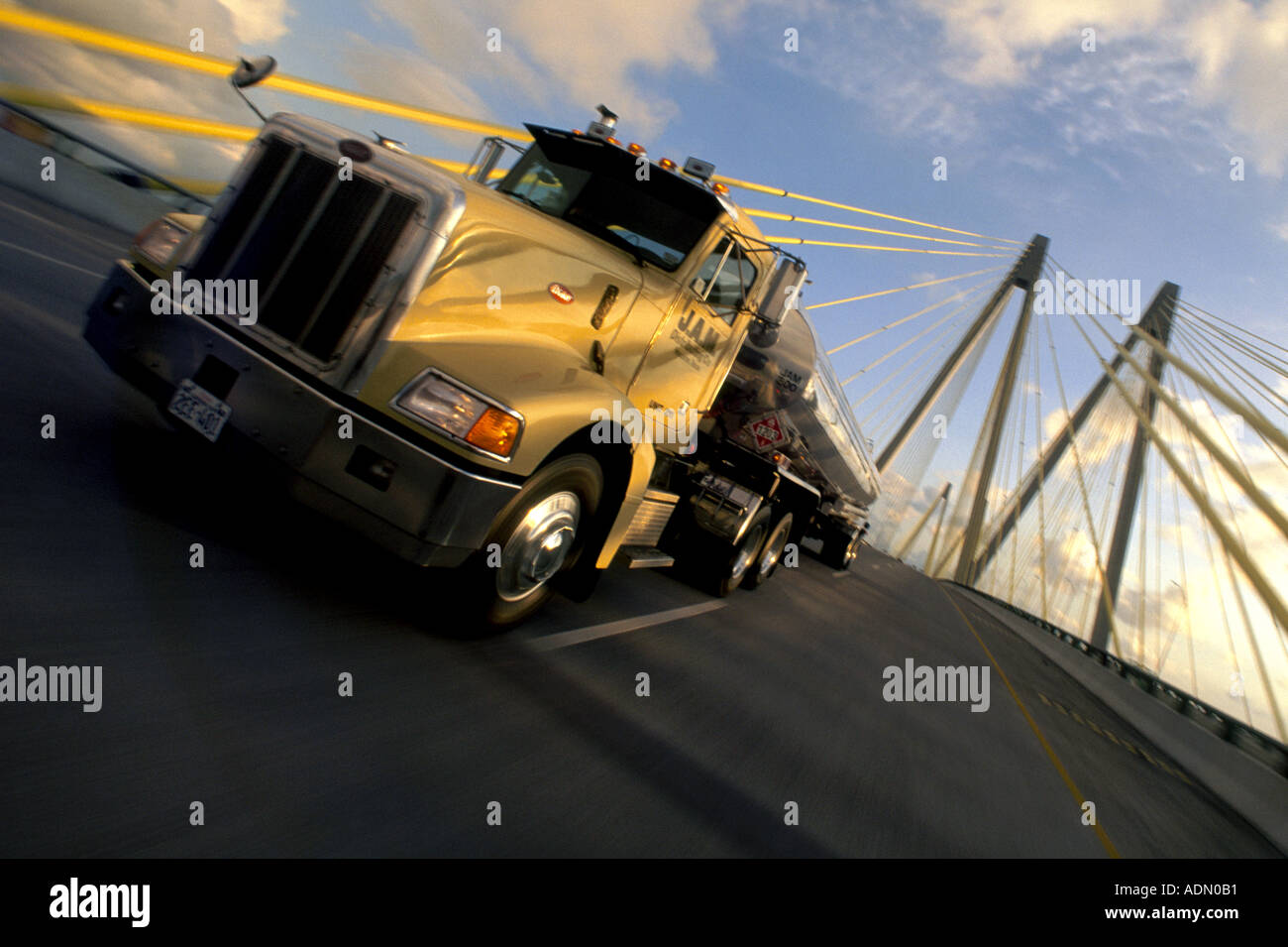 On his way to deliver his load a trucker crosses over a bridge in