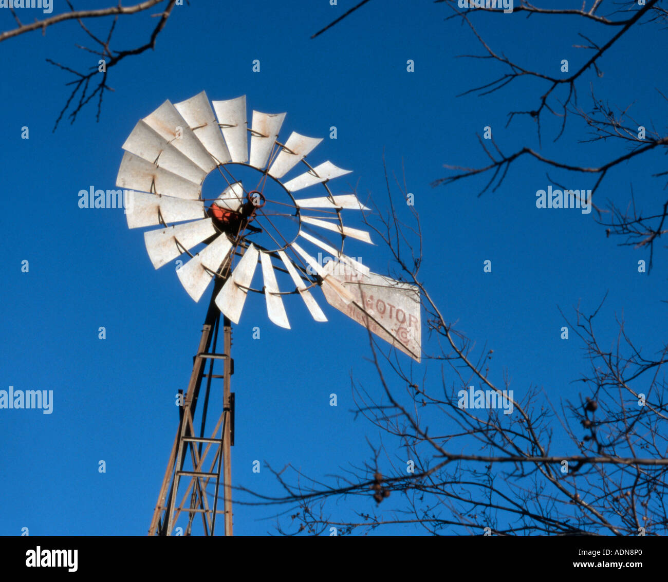Windmill water pump used for agricultural and ranch irrigation against blue Texas sky Stock Photo