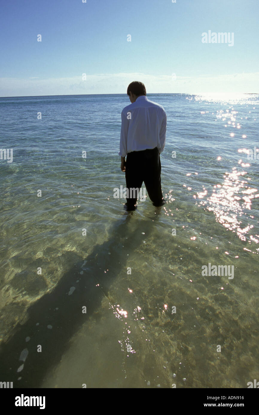 Businessman standing in sea Stock Photo