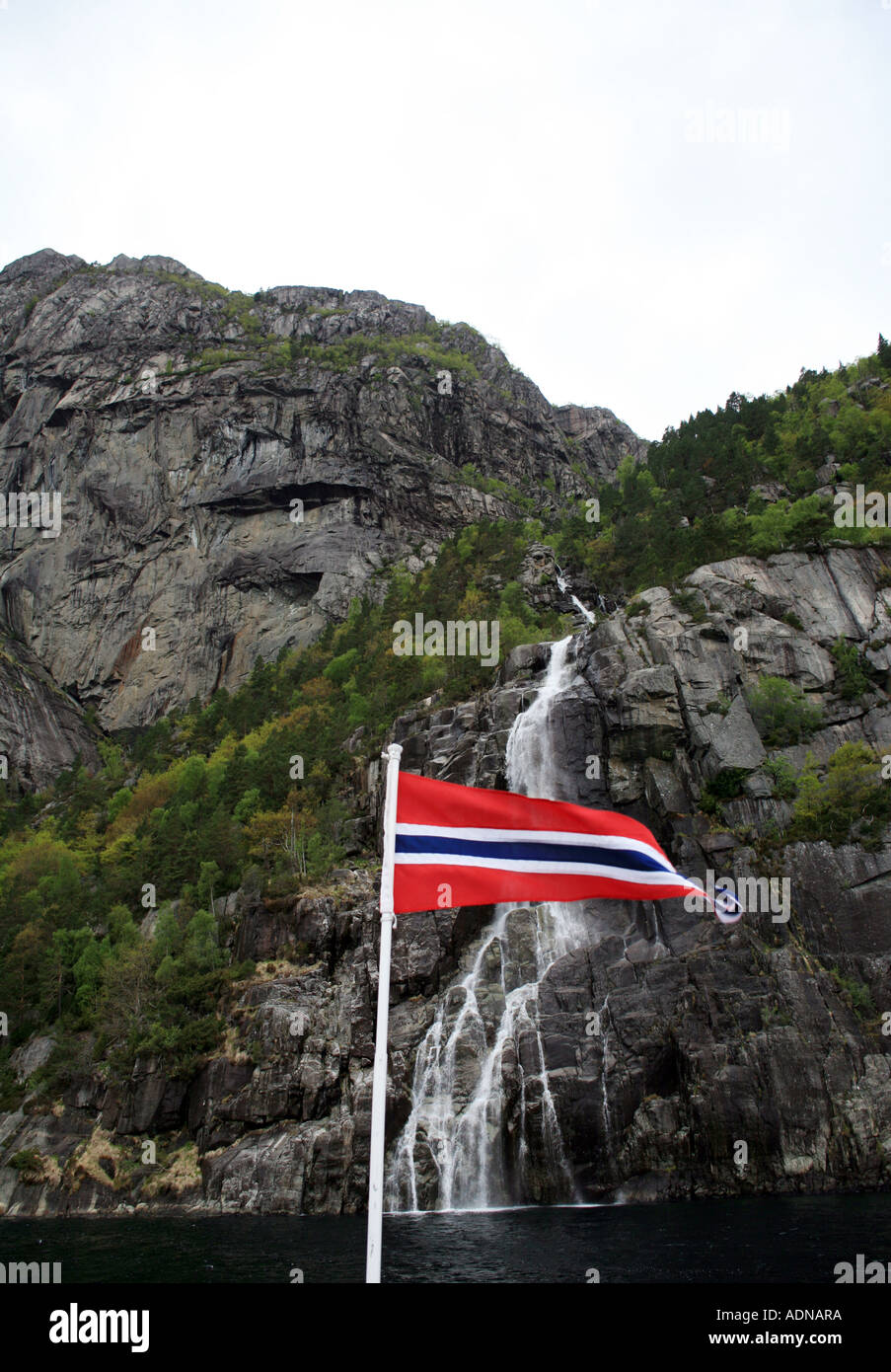 Whisky waterfalls with Norwegian ensign, Stavanger fjords Norway Stock Photo