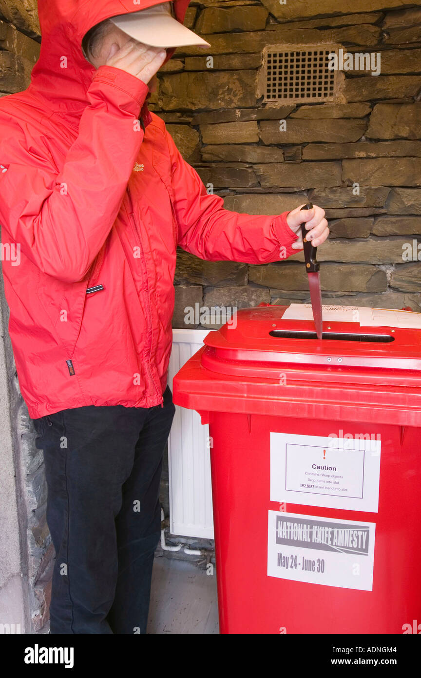 a man depositing a knife in a knife bin during the knife amnesty, at