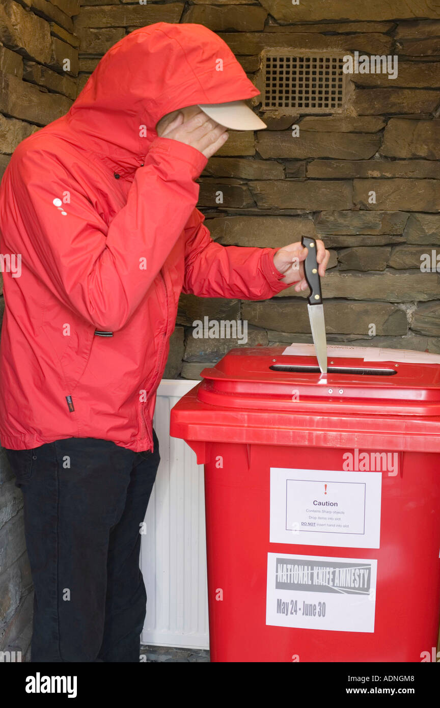 a man depositing a knife in a knife bin during the knife amnesty, at windermere police station