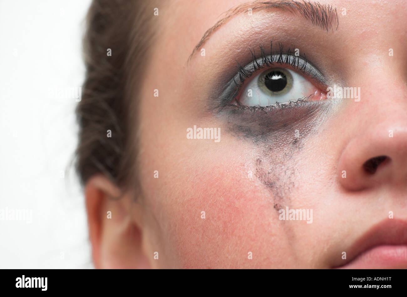 Young woman crying mascara running down cheek Stock Photo - Alamy