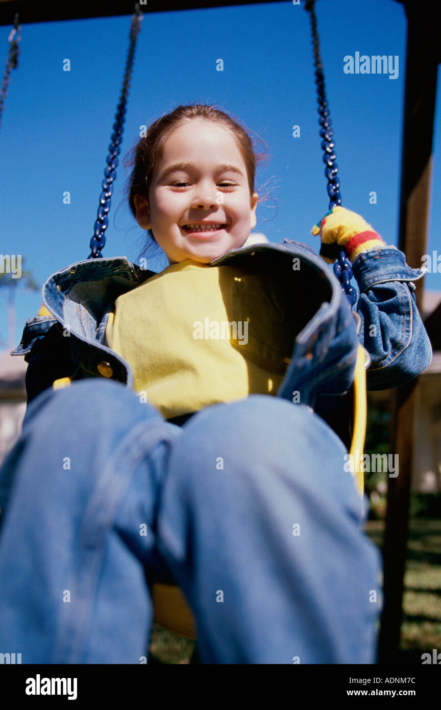Portrait of a girl sitting on a swing Stock Photo - Alamy