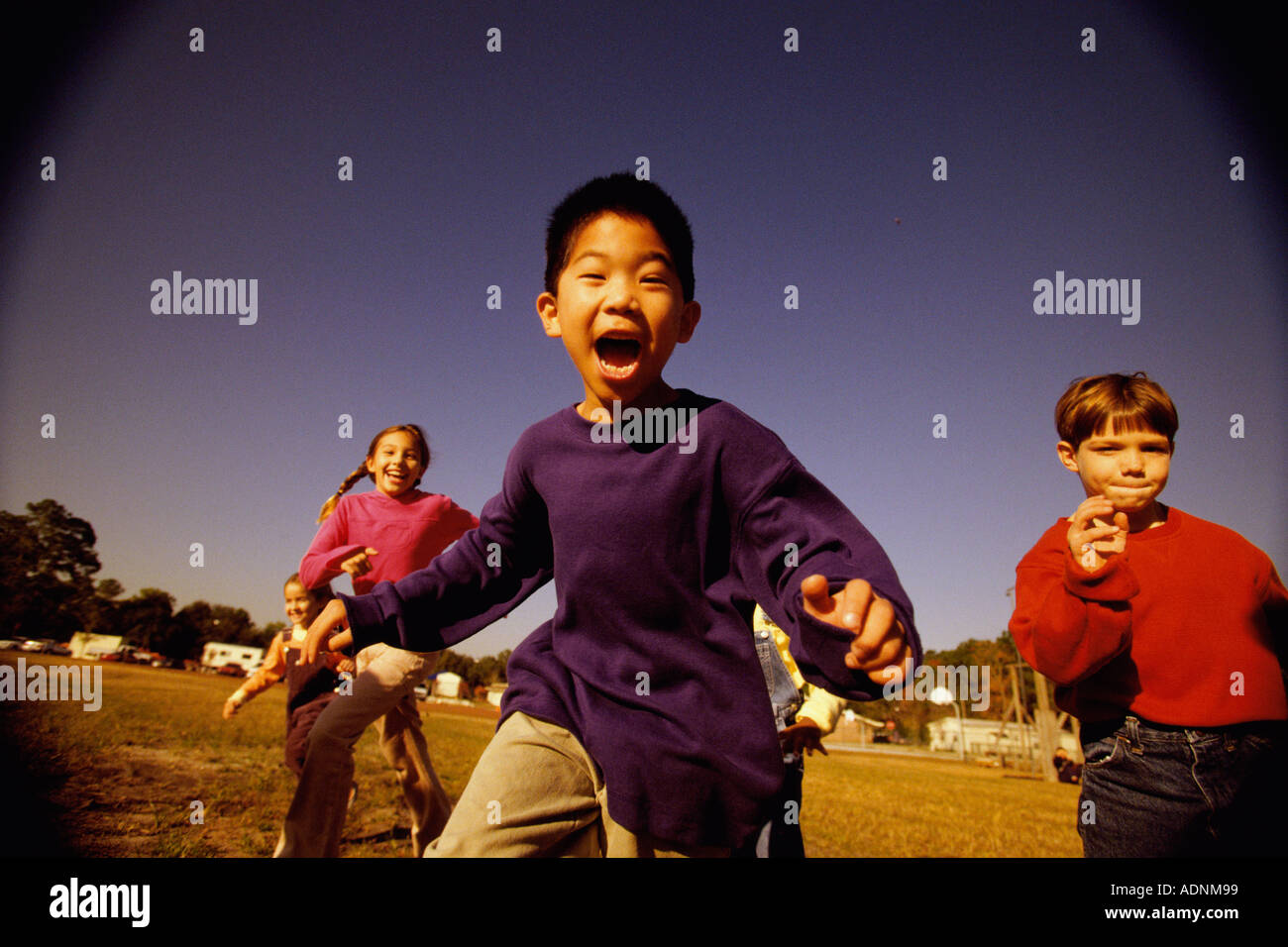 Group of children running in a park Stock Photo - Alamy