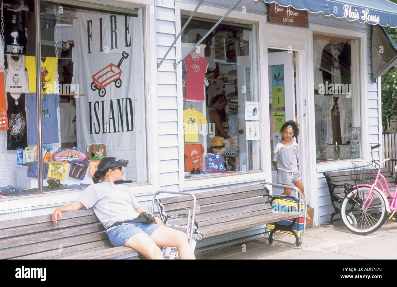 Woman Sitting On Bench In Front Of Store Ocean Beach Fire Island