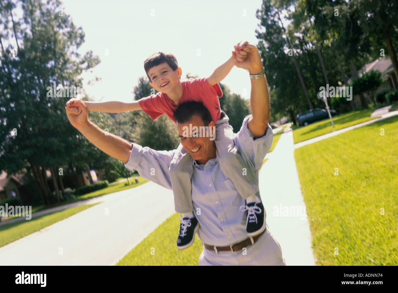 Father carrying his son on his shoulders Stock Photo - Alamy