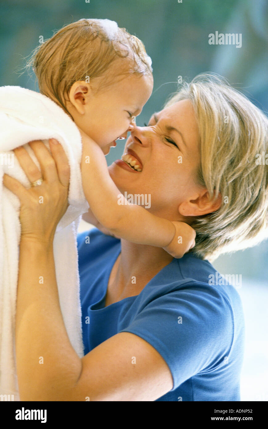 Side profile of a mother lifting her baby boy nuzzling Stock Photo Alamy