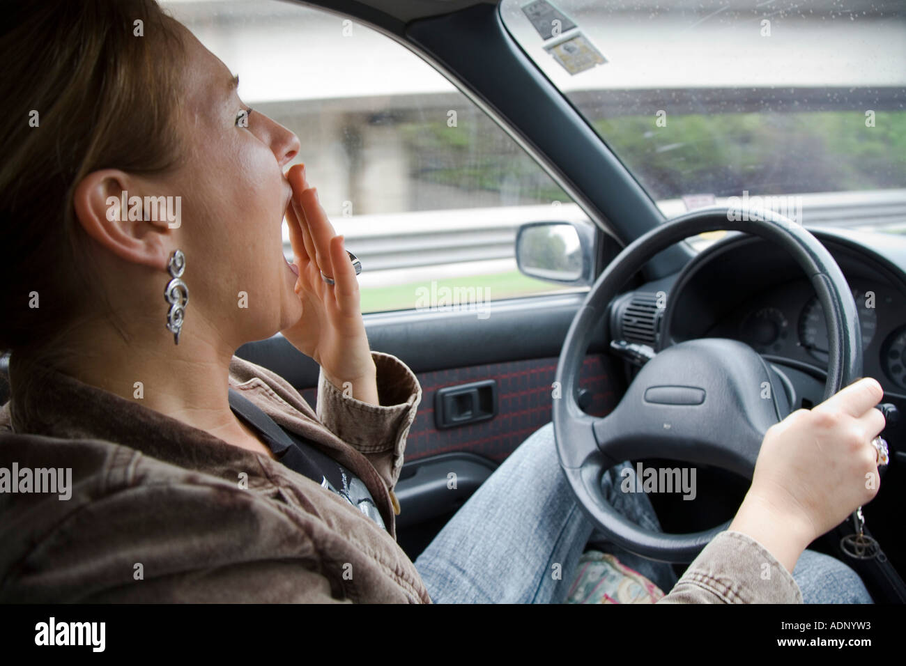 https://c8.alamy.com/comp/ADNYW3/symbol-photo-woman-is-in-a-tired-way-at-the-steering-wheel-ADNYW3.jpg