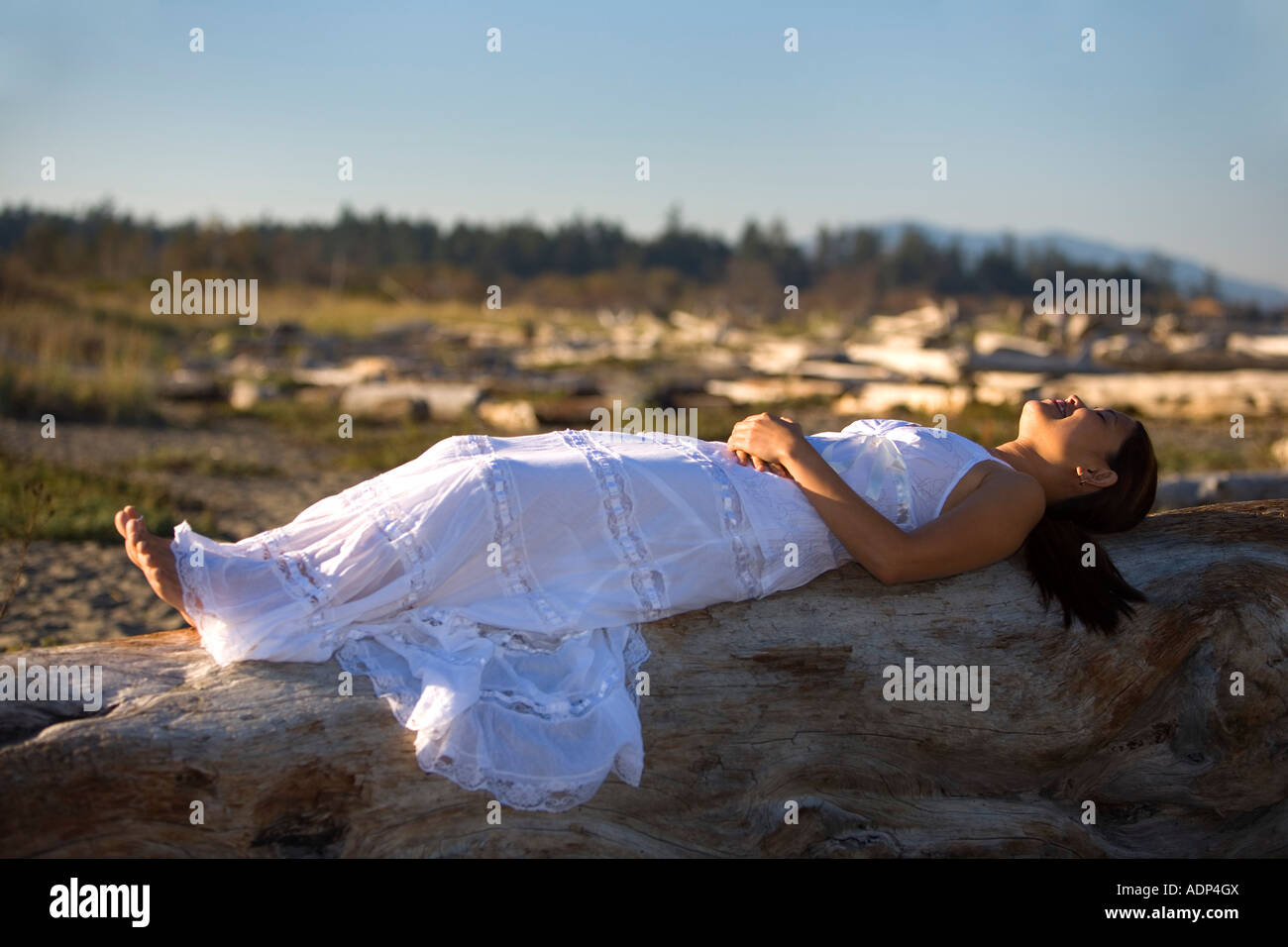 A Filipino woman wearing a white dress on the beach Stock Photo - Alamy