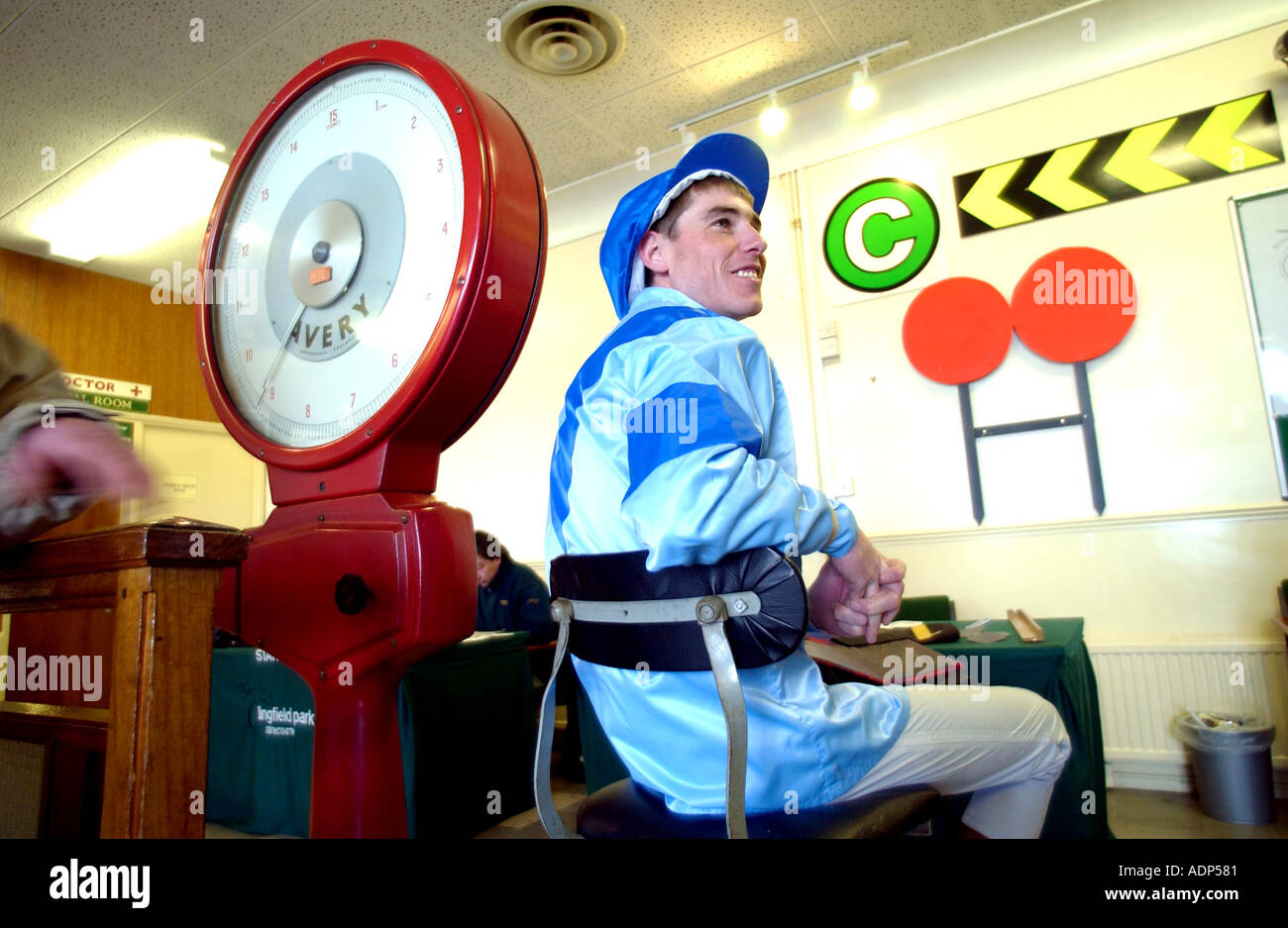 Weighing in. A jockey in his silks on the scales before his race Stock  Photo - Alamy
