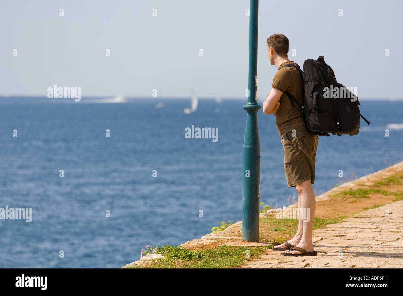 Hitchhiker watching sea Stock Photo